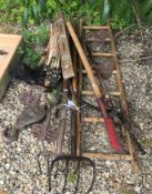 A collection of hand tools to include mattock and forks,