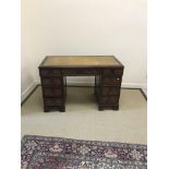 A reproduction mahogany kneehole desk,