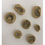 A collection of seven brass moulds, probably for jewellery and Indian,