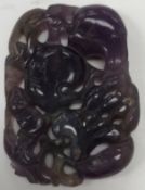 A Chinese carved amethyst pendant decorated with various fruits, 5.