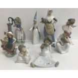 A collection of twelve Lladro figures including "Girl at pump with geese", "Two nuns",