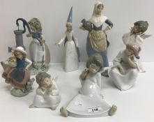 A collection of twelve Lladro figures including "Girl at pump with geese", "Two nuns",