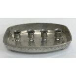 A collection of various candle holders including a Munka pewter four section candle stand,