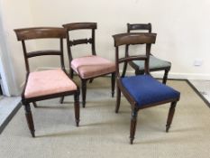 A set of four Victorian mahogany bar back dining chairs on turned and reeded front legs,