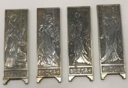 A set of four Chinese white metal cast miniature screen panels, each depicting a female figure,