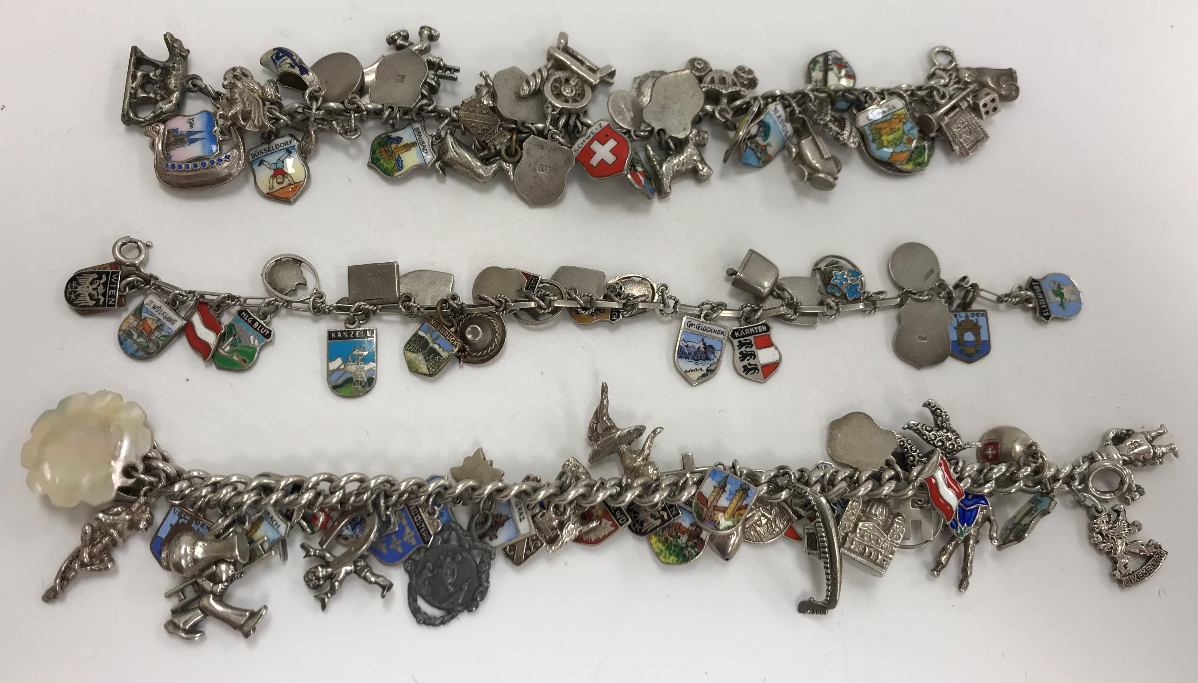 Three various mid 20th Century silver and white metal charm bracelets, - Image 3 of 3