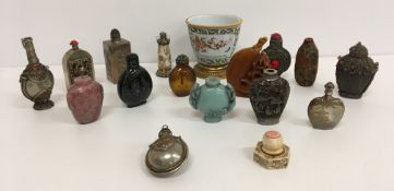 A collection of various Chinese scent bottles to include metal, glass and carved stone examples,