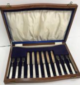 A cased set of six silver bladed and tined mother of pearl handled fruit knives and forks (by James