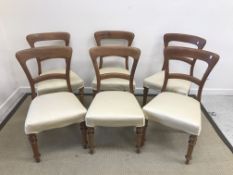 A set of six Victorian mahogany bar back dining chairs with upholstered seats on turned front legs