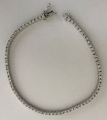 A 9 carat white gold diamond set tennis bracelet, approx 1 carat stones total, 18 cm long, 7.