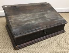 A 17th Century and later oak Bible box, the slope top with iron hinges,