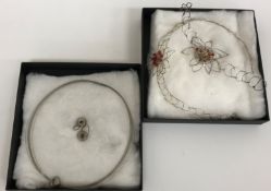 A silver and wire work decorated necklace and earrings set of simple single beaded form,