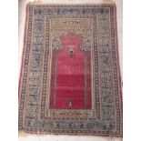 A Persian prayer rug with Mahib design and a stepped beige and blue pseudoscript decorated border