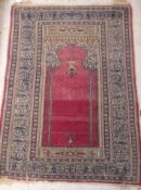 A Persian prayer rug with Mahib design and a stepped beige and blue pseudoscript decorated border