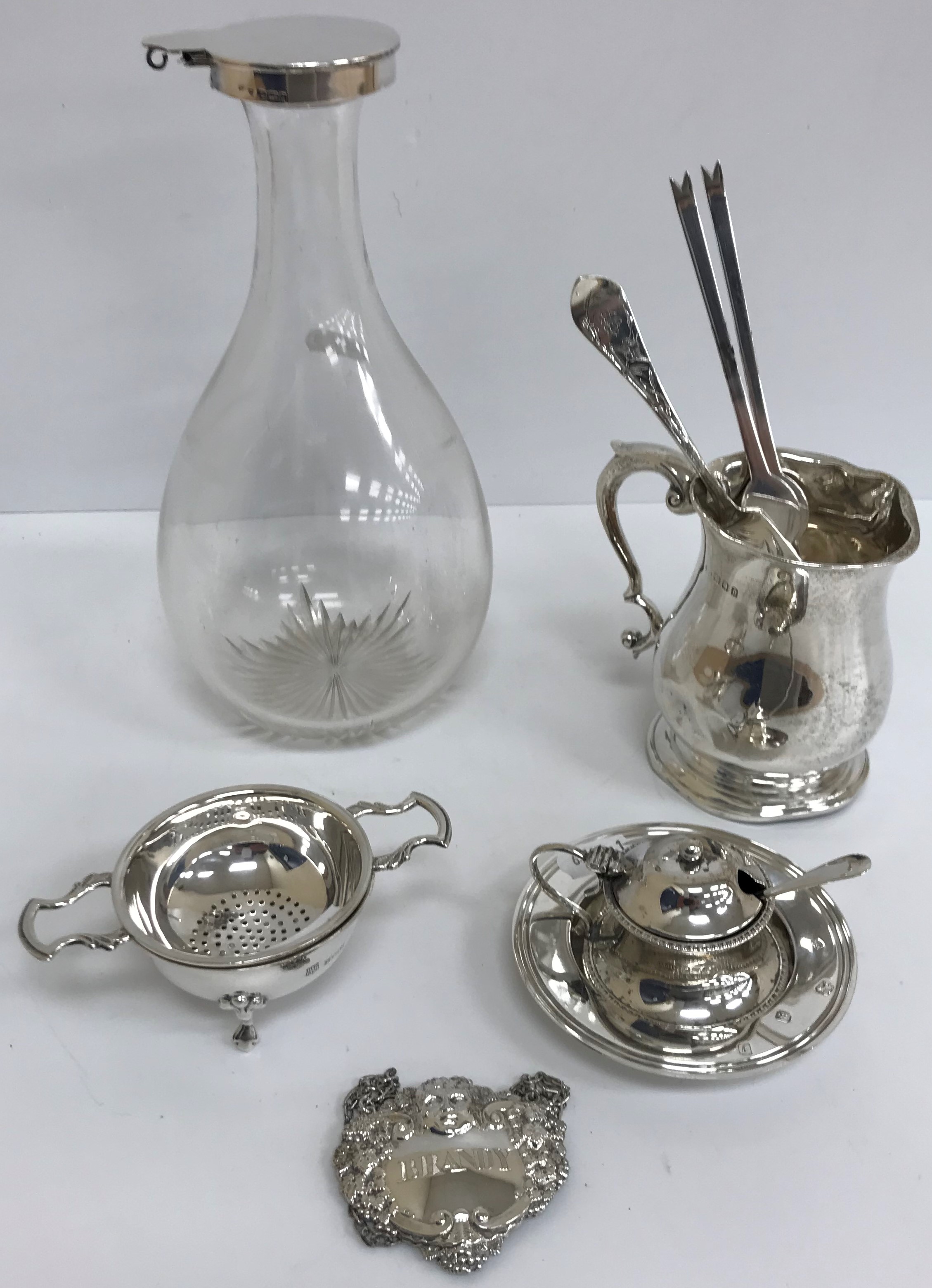 A silver mounted decanter of plain teardrop form (by John Grinsell & Sons, Birmingham 1903),