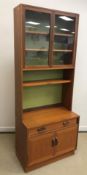 A G Plan teak display cabinet with two glazed doors over a shelf and a recess on a base with single