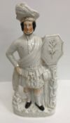 A collection of thirteen various Staffordshire figures including "Rob Roy", 47 cm high,