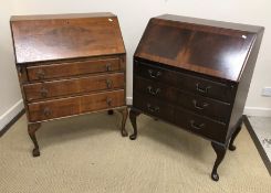A 20th Century mahogany and cross banded bureau of three long drawers on cabriole legs to pad feet