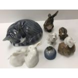 A collection of seven Royal Copenhagen animal figures including "Sleeping cat" (057),