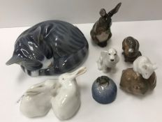 A collection of seven Royal Copenhagen animal figures including "Sleeping cat" (057),