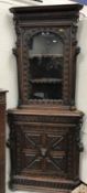 A Victorian carved oak Gothic Revival corner cabinet, the upper section with gadrooned,