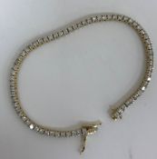 A 14 carat gold tennis bracelet, comprising 69 stones, each approx 0.05 carat, total weight 12.