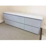 A modern six drawer dwarf chest of plain form in pale grey, 185.5 cm wide x 49.5 cm deep x 68.