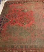 An Ushak design carpet, the central panel set with stylised foliate decoration on a red ground,