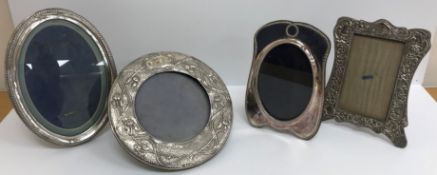 A collection of four silver photograph frames,