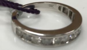 A 9 carat white gold and diamond mounted band, size P/Q,