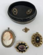 A Victorian mourning brooch with amethyst stone set to centre,