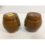 A pair of Chinese treacle glazed pottery miniature barrel shaped garden seats, 7.