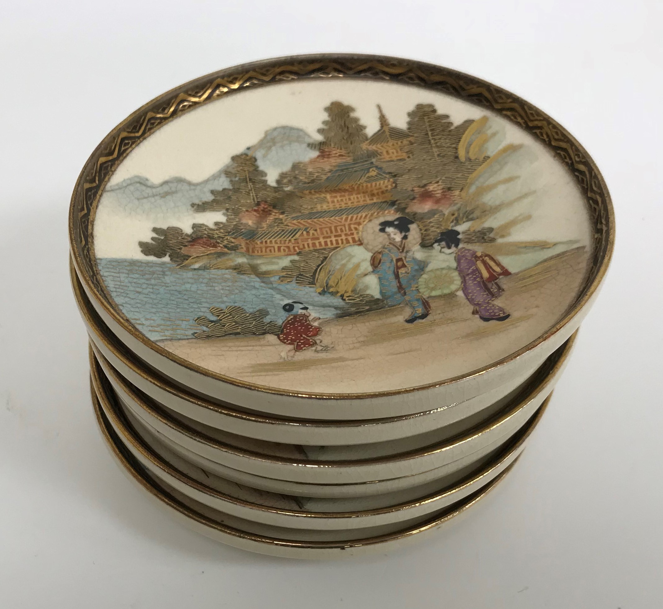 A Meiji period Satsuma pottery set of six cups and saucers with figural and costal landscape - Image 3 of 4