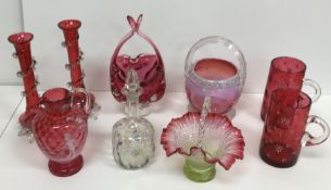 A collection of cranberry glassware to include a Mary Gregory style jug,