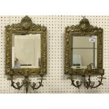 A pair of circa 1900 brass framed girandoles in the Continental manner with Bacchus mask decorated