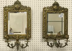 A pair of circa 1900 brass framed girandoles in the Continental manner with Bacchus mask decorated