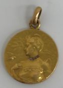 An early 20th Century yellow metal pendant by Jean Baptiste Emile Dropsey,
