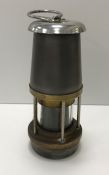 A William Maurice miner's lamp of typical form, with vacant brass plaque to top and glazed gauze,