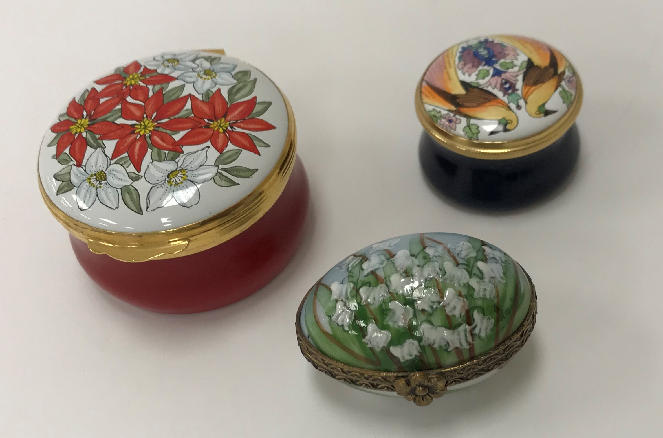 A collection of various porcelain and enamelled boxes and bonnieres,