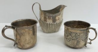 A silver Christening mug of plain form (by A & J Zimmerman Ltd, Birmingham 1924),