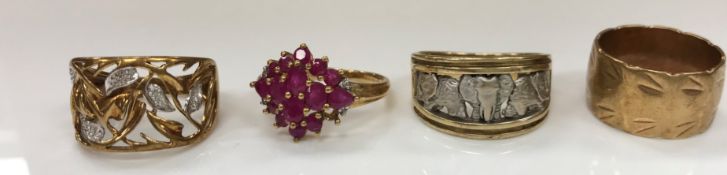 A collection of four 9 carat gold dress rings, one red stone set,