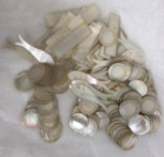 A collection of mother of pearl gaming tokens comprising 18 fish tokens,