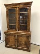 A Victorian walnut and marquetry inlaid bookcase cabinet,