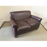 A modern brown leather upholstered "Burlington" two seat scroll arm sofa on square tapered legs in