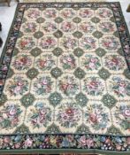 An Aubusson carpet, the central panel set with all-over floral decoration on a cream ground,