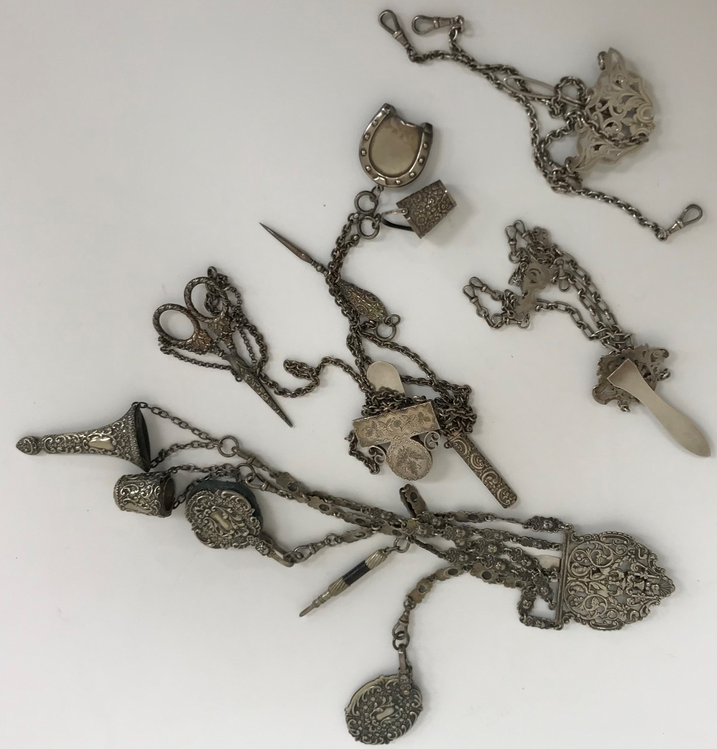 A Victorian silver plated chatelaine with five hanging chains,