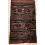A tribal Kelim bag with repeating striped design in blue, red, green, etc,