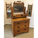 A circa 1900 oak two door display cabinet with leaded glazed panels enclosing adjustable shelving
