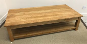 A modern oak two tier coffee table on square supports 160 cm wide x 80 cm x 40 cm high