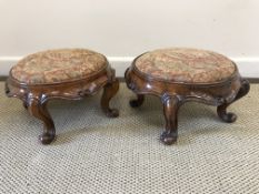 A pair of Victorian upholstered circular stools, raised on scrolling feet,